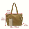 A tan corduroy handbag with a vertical slot for a smartphone.
