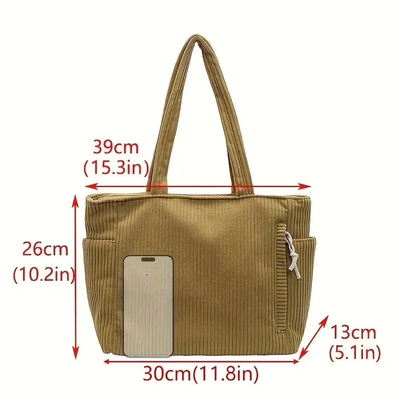 A tan corduroy handbag with a vertical slot for a smartphone.
