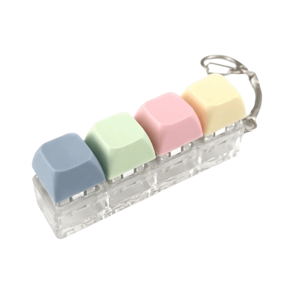 A clear plastic keyboard fidget toy with five pastel colored silicone keys arranged in a row.