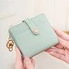 A light mint green minimalist RFID blocking wallet is being held by a person, showing its design and hardware.