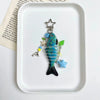 A colorful simulation fish keychain featuring blue scales, a green fin, and a silver star charm.