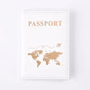 A beige leather passport holder with gold embossed text and a world map silhouette.