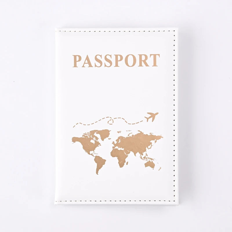 A beige leather passport holder with gold embossed text and a world map silhouette.
