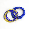A stack of colorful belly bead chains featuring blue and gold beads.