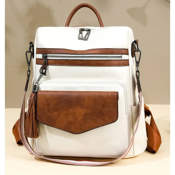 A white and brown retro PU leather travel backpack with a zippered pocket and tassel detail.