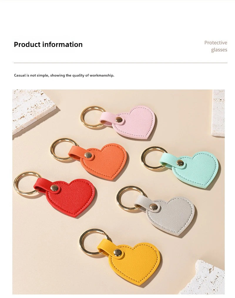 A collection of colorful leather heart keychains in pink, orange, red, green, and yellow displayed on a light background.