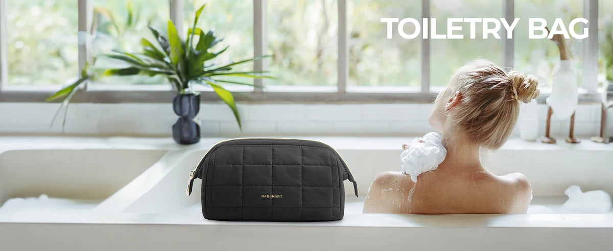 A woman is washing her hair in a bathtub while a padded makeup bag rests on the edge of the tub.