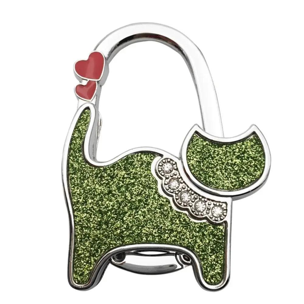 Silver handbag hooks shaped like a cat's head with green glitter texture