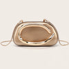 A smooth, gold-tone evening clutch bag with a curved design and thin gold chain strap.
