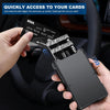 A hand holds a slim black card wallet with multiple cards, including a Visa card, next to a car interior.