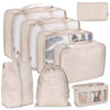 A set of seven beige and white folding storage bags for travel organization.