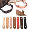 A collection of leather handbag carry loops and straps in various shades including brown, tan, pink, and black.