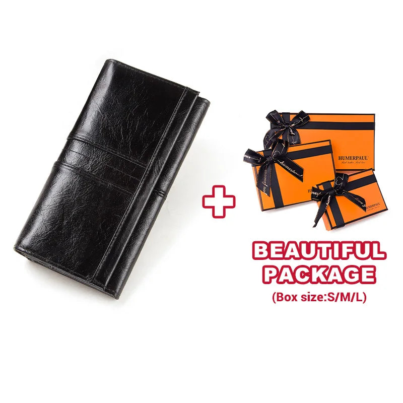 Black genuine leather clutch wallet and two orange gift boxes with black ribbon