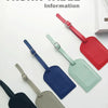 A collection of PU leather luggage tags in various colors, including red, green, blue, and gray, displayed on a white surface
