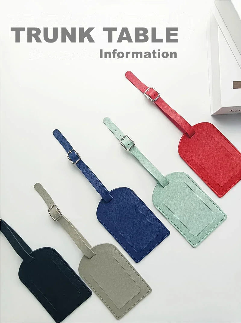 A collection of PU leather luggage tags in various colors, including red, green, blue, and gray, displayed on a white surface