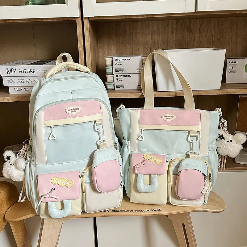 A light blue and pink Kawaii Harajuku backpack with a laptop compartment displayed on a wooden shelf.