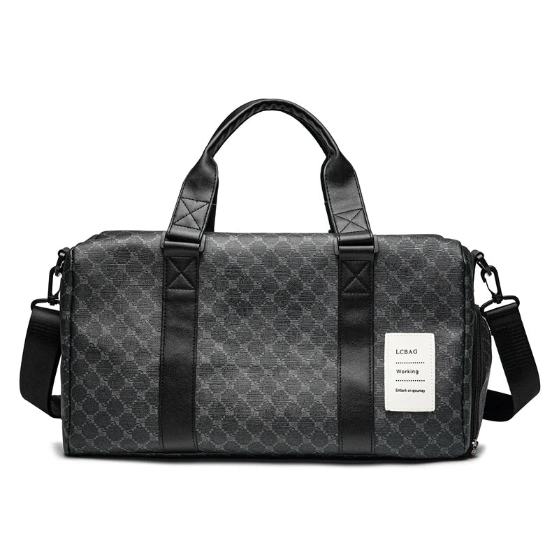 A black leather duffle bag with padded straps and a patterned fabric exterior is shown against a white background.