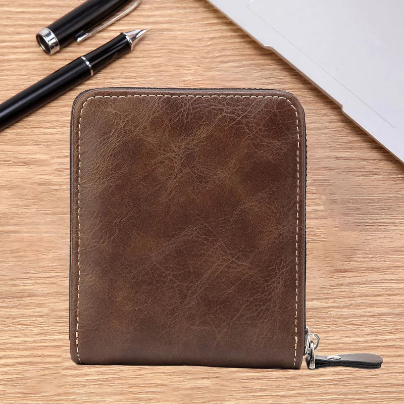 A brown men's PU waxed oil leather bifold wallet resting on a wooden surface next to a pen.
