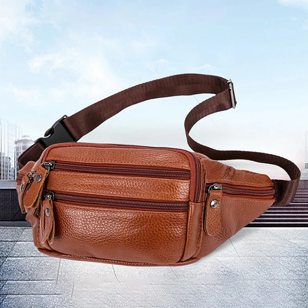 A brown genuine leather men's waist bag is shown lying on a gray tiled surface.
