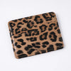 A brown and black leopard print slim card holder wallet.