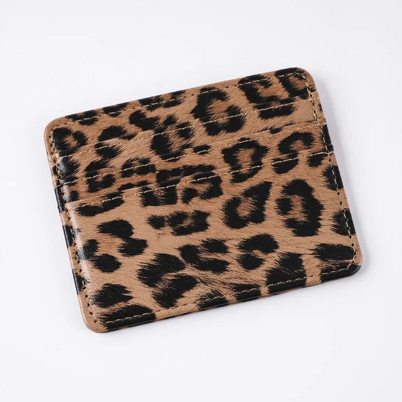 A brown and black leopard print slim card holder wallet.