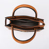 A tan leather handbag with a curved handle and flap, shown against a white background.