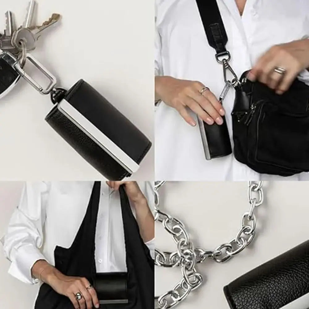 A black foldable mini keychain tote bag is shown attached to a silver chain, held by a person.