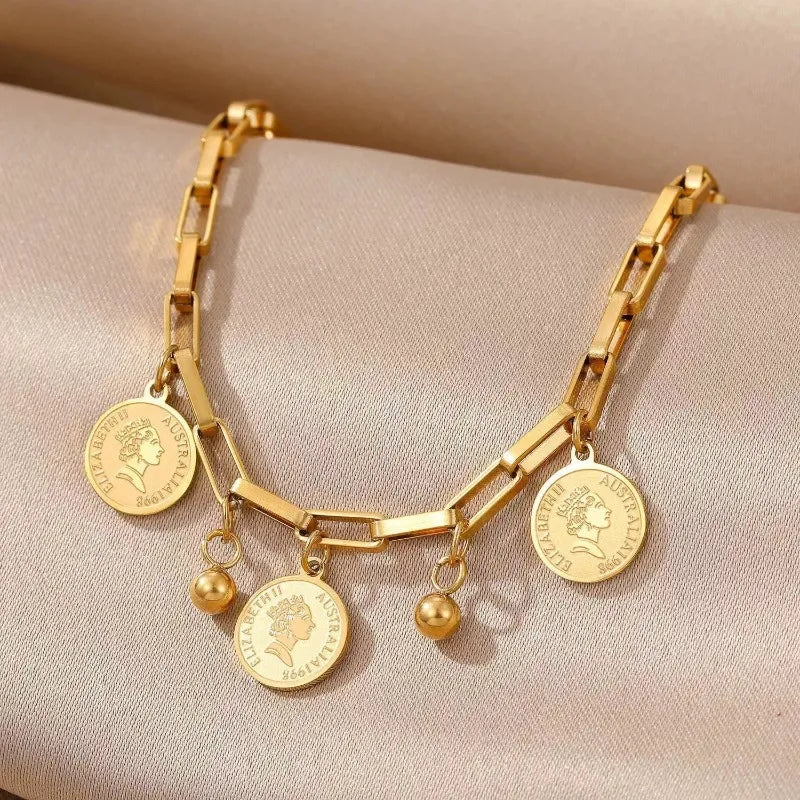 A gold stainless steel charm bracelet featuring portrait pendants with Australian themes.