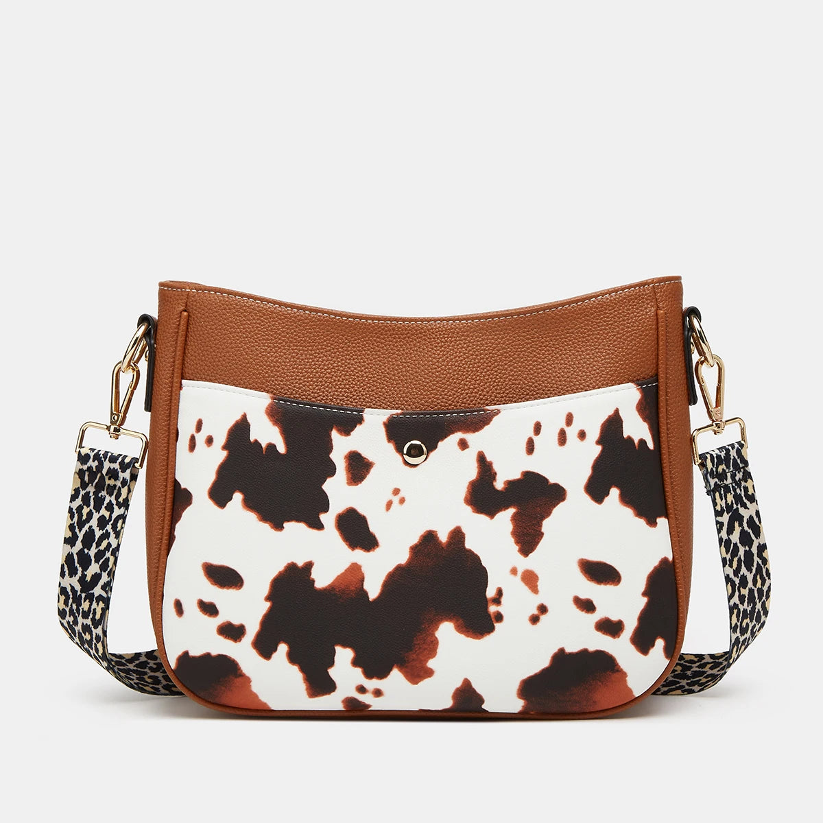 Sac à main en cuir PU motif vache marron et blanc avec quincaillerie dorée.