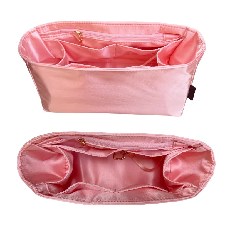A pink luxury bag organizer insert featuring a silk lining and multiple compartments.