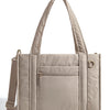 A beige quilted tote bag with a flap closure and a detachable strap is shown against a white background.