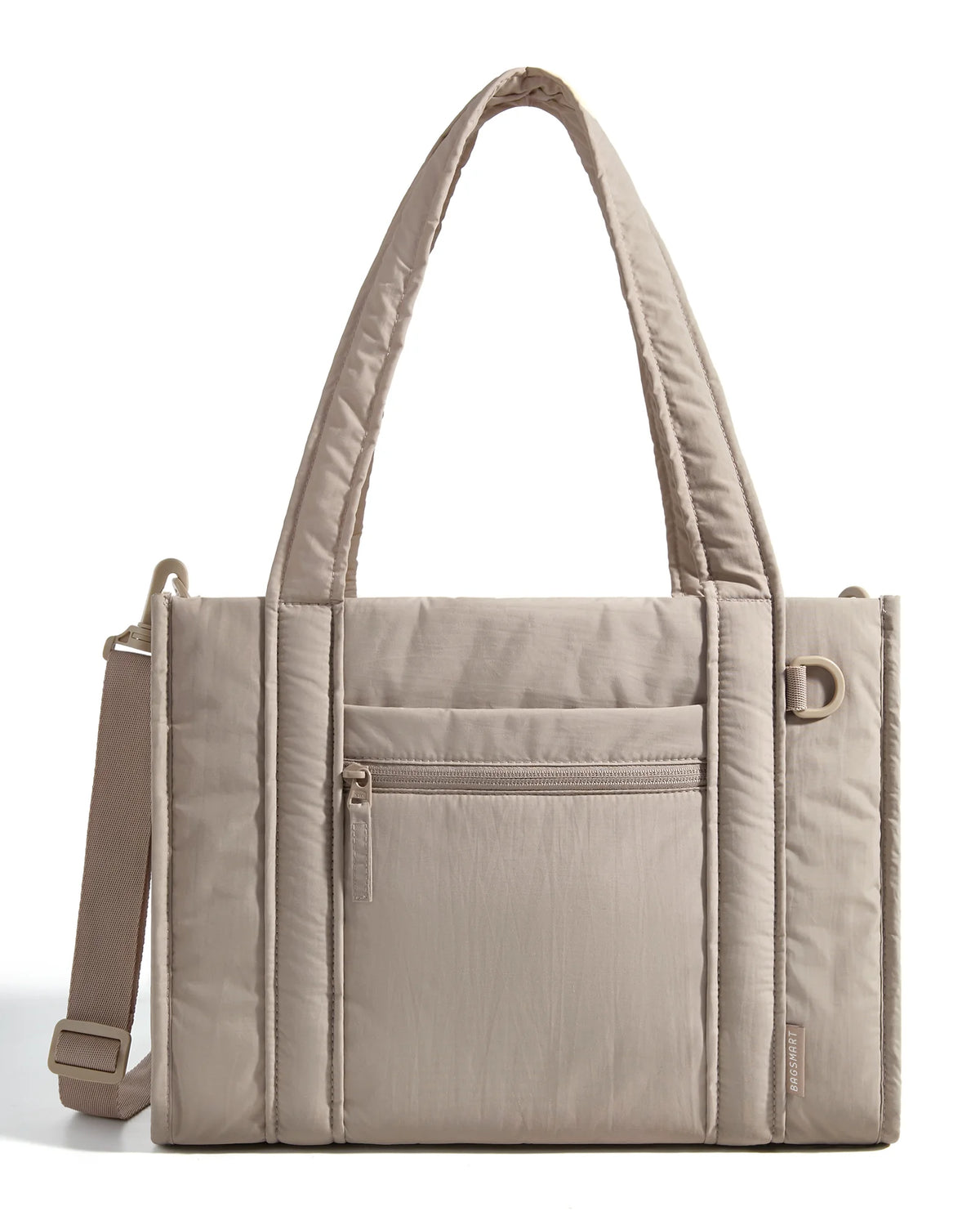 A beige quilted tote bag with a flap closure and a detachable strap is shown against a white background.