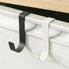 A black and white heavy duty hook rack installed on a cabinet door frame.