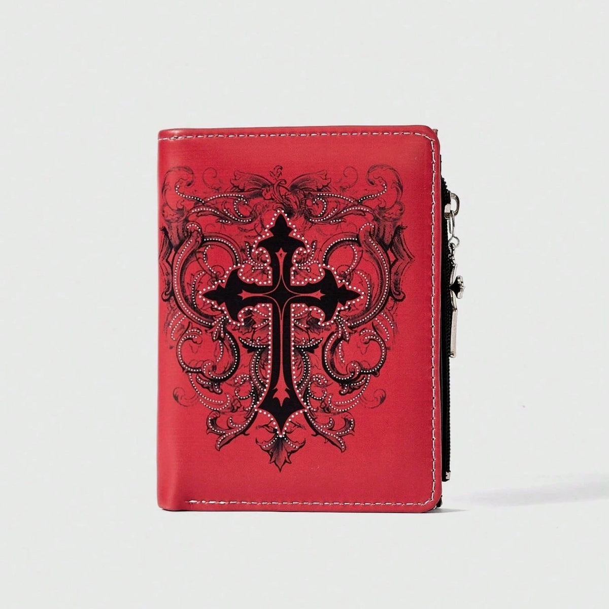 A red leather wallet featuring a black gothic cross pattern embossed on the cover with a zipper closure.