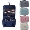 Dunkelblaue tragbare Reise-Toilettenorganizer-Tasche mit Reißverschlussfache und separatem Pinselhalter.