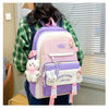 A pink and purple nylon backpack set featuring cartoon designs carried by a person.