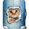 A denim suitcase cover featuring a realistic cat face design with torn edges.