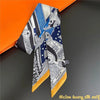 A silky twill ribbon scarf featuring a pattern of blue, white, and orange stripes displayed against an orange background.