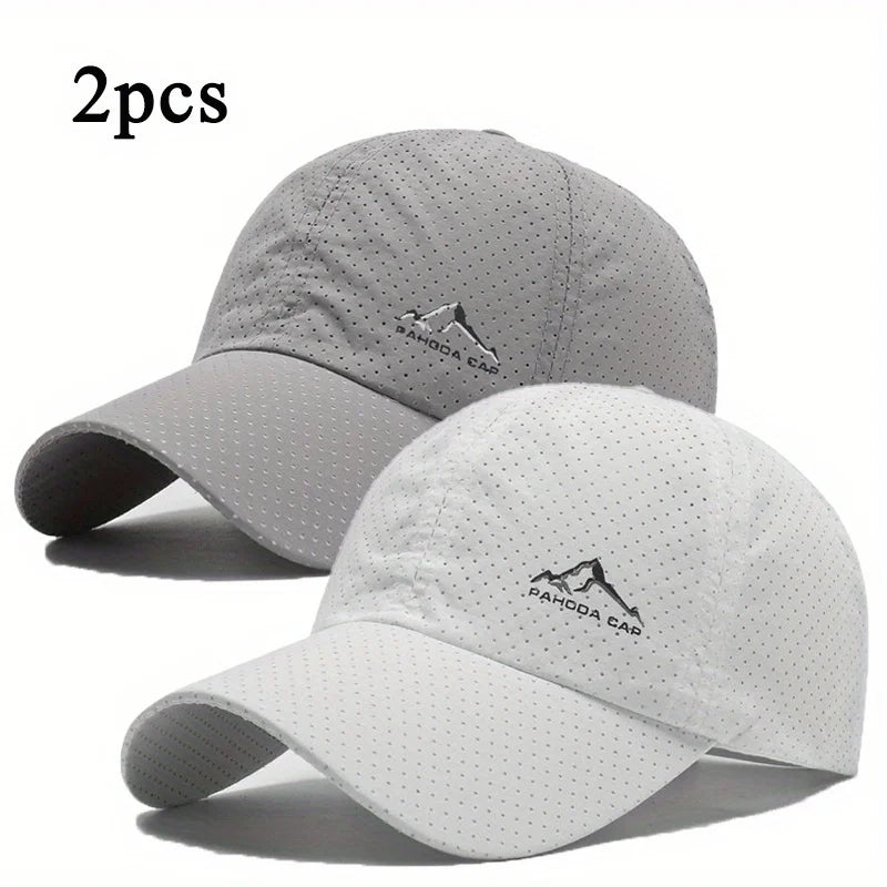 A set of two light gray and white outdoor baseball caps shown against a white background.