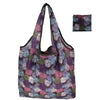 A reusable tote bag made of eco-friendly nylon with a floral pattern in purple, green, and pink tones.