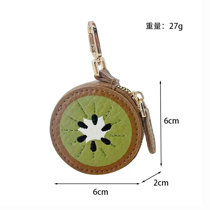 A light green fruit-shaped PU leather coin purse keychain with a brown leather strap and gold hardware.