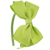 A bright lime green satin bow headband shown against a white background.