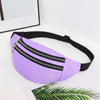 A purple nylon crossbody sling bag with a silver zipper is displayed on a white surface.