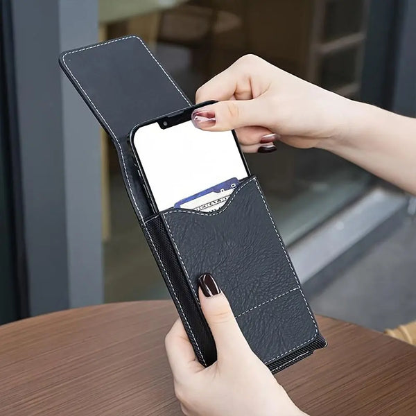 A hand is holding a black PU leather phone waist pouch with a belt clip, displaying a smartphone.