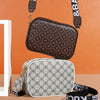 A brown patterned fashion crossbody bag is displayed against an orange background, with a gray patterned bag nearby.