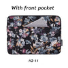 Black floral laptop sleeve with a front pocket and a light gray phone visible inside.
