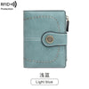 A light blue multi-fold wallet with decorative stitching and a gold-colored emblem.