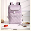 A light purple insulated picnic cooler backpack with black accents sitting on a white table.