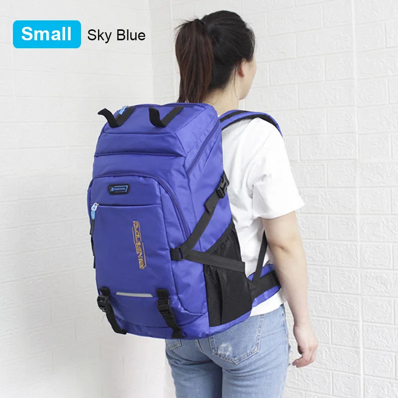 A small sky blue backpack is shown on a person's back against a white brick wall.