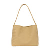 A beige woven straw bucket shoulder bag with a long strap.